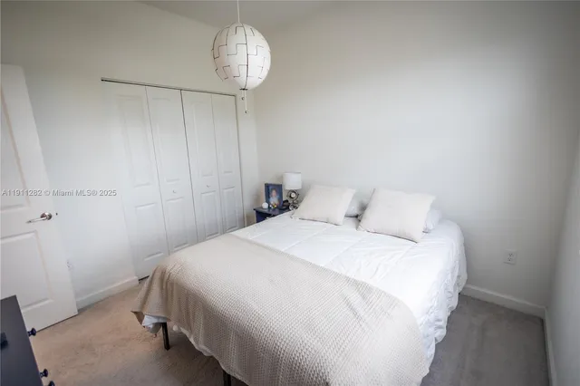 a bedroom with a bed and chandelier