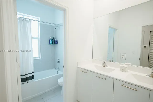 a bathroom with a tub sink shower and mirror