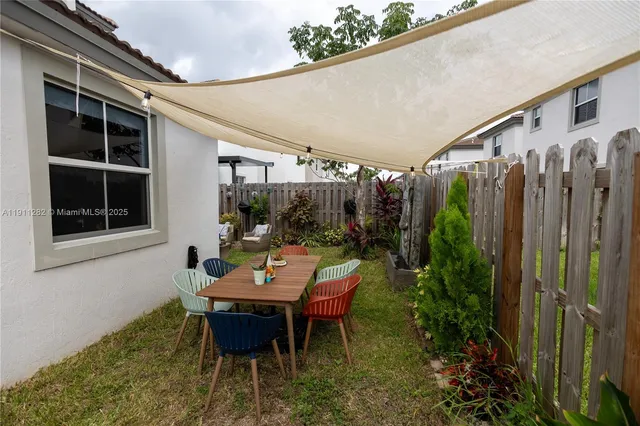 a backyard of a house with yard barbeque oven and outdoor seating