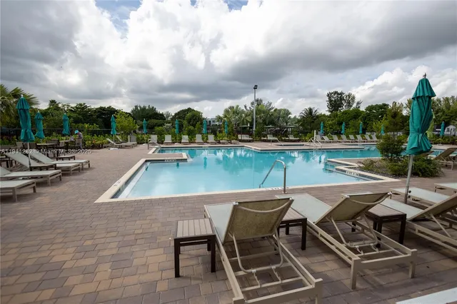 an outdoor space with swimming pool and furniture
