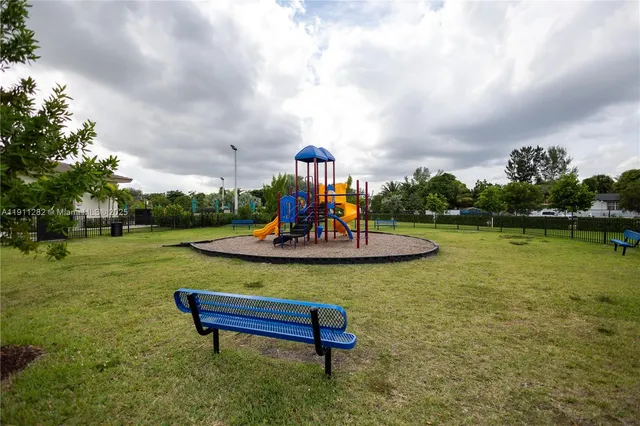 a view of a park with plants and lake view