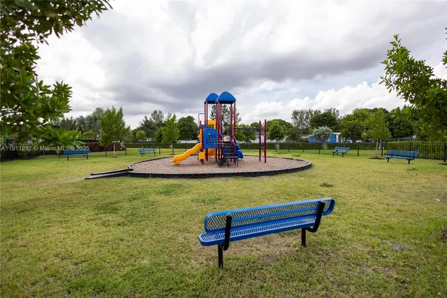 a view of a swimming pool with a bench and lawn chairs