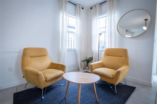 a living room with furniture and a mirror