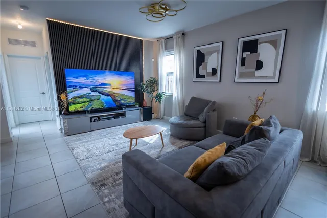 a living room with furniture and a flat screen tv