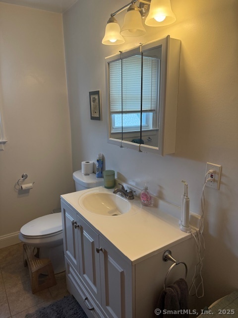 18 Walnut Street Bristol, CT 06010 - Photo 11 of 13 a bathroom with a sink a toilet and mirror