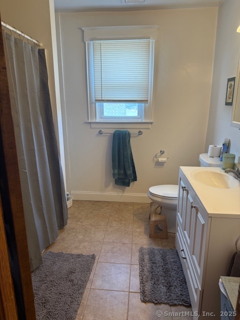 18 Walnut Street Bristol, CT 06010 - Photo 12 of 13 a bathroom with a sink a toilet and a mirror