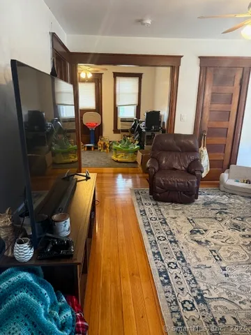 a living room with furniture rug and wooden floor