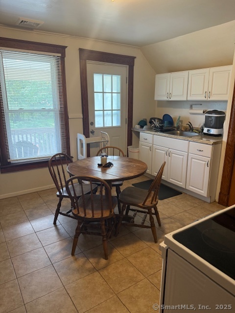 18 Walnut Street Bristol, CT 06010 - Photo 7 of 13 a kitchen with a dining table and chairs