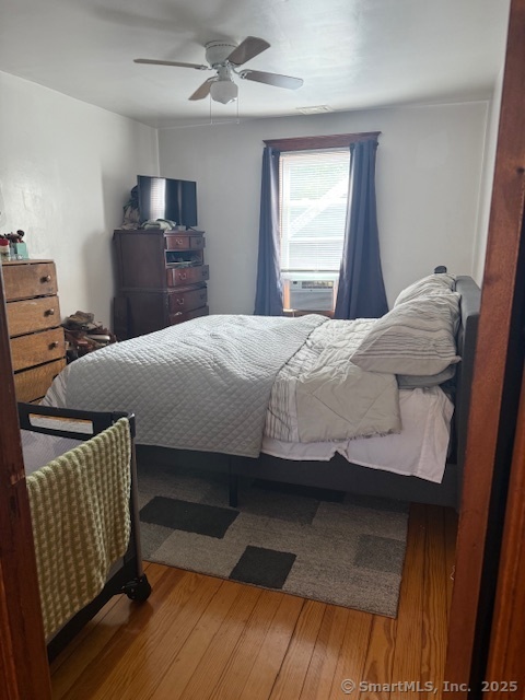18 Walnut Street Bristol, CT 06010 - Photo 8 of 13 a bedroom with a bed and wooden floor