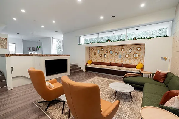 a living room with furniture a rug and a fireplace