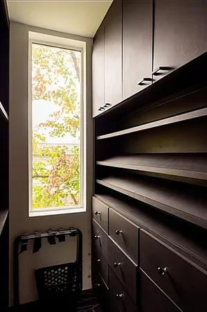 a bedroom with a bed and a large window