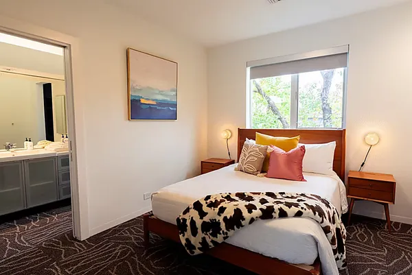 a living room with furniture and a floor to ceiling window