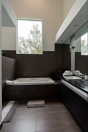 a bathroom with a double vanity sink and a mirror