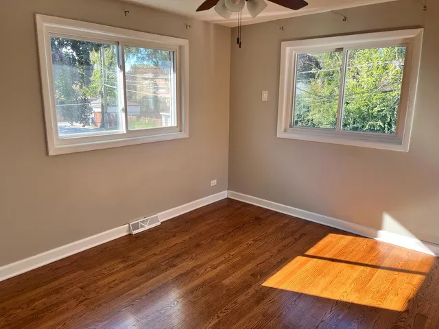 a room with a hardwood floor and a window