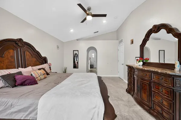 a bedroom with a bed a dresser and window