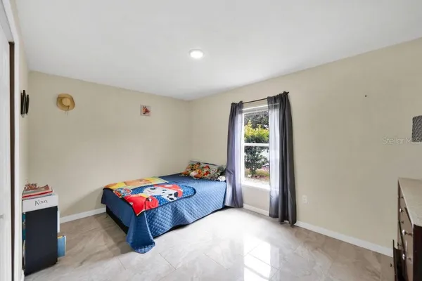 a bedroom with a bed and a window