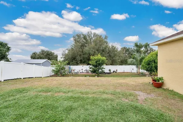 a view of a yard with basketball court