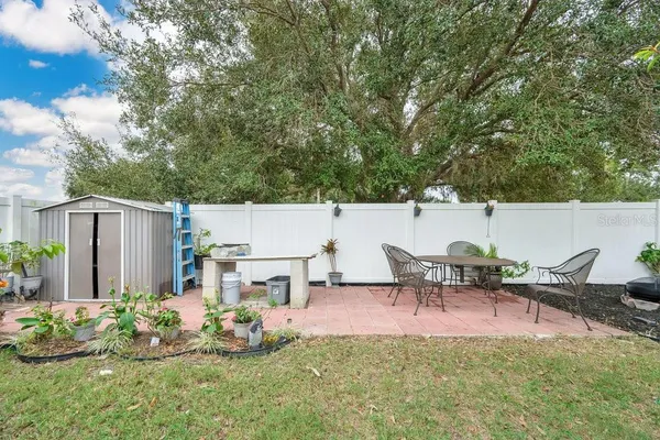 a backyard of a house with table and chairs