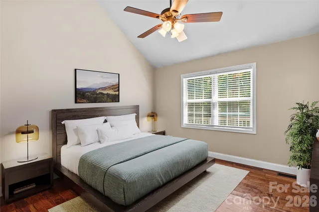 a bedroom with a bed lamp and a chandelier