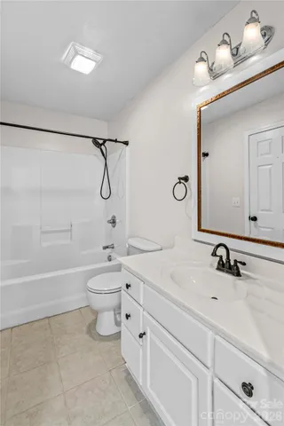 a bathroom with a toilet a sink a mirror and bathtub