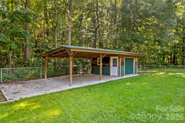 a view of a house with a yard and sitting area