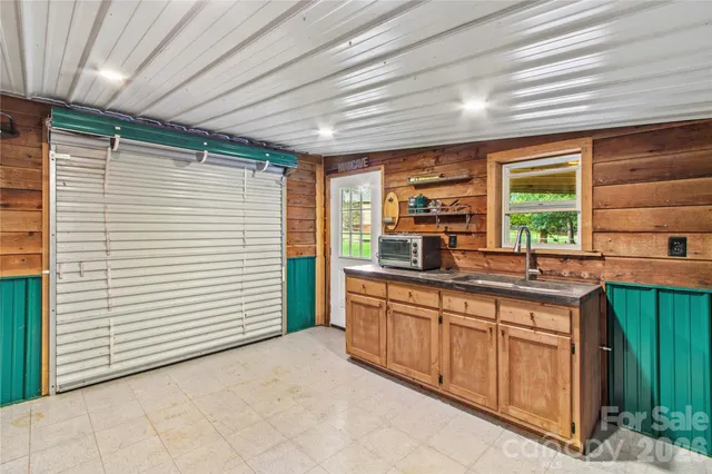 a view of a kitchen with a sink and cabinets