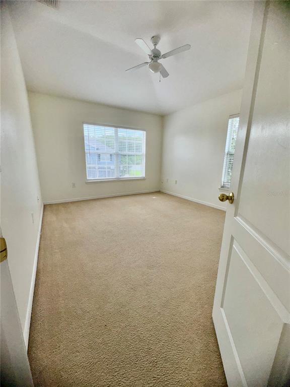 6404 South Goldenrod Road, Unit 2A Orlando, FL 32822 - Photo 18 of 40 an empty room with windows