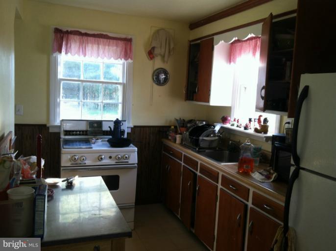 2408 Sheraton Street Silver Spring, MD 20906 - Photo 6 of 11 a kitchen with a stove a refrigerator and a sink