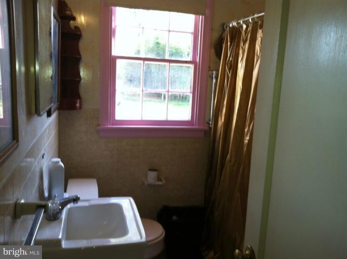 2408 Sheraton Street Silver Spring, MD 20906 - Photo 7 of 11 a bathroom with a sink a toilet and a mirror