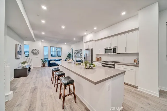 a view of kitchen with cabinets appliances and wooden floor