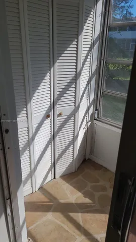 a view of an empty room and a window