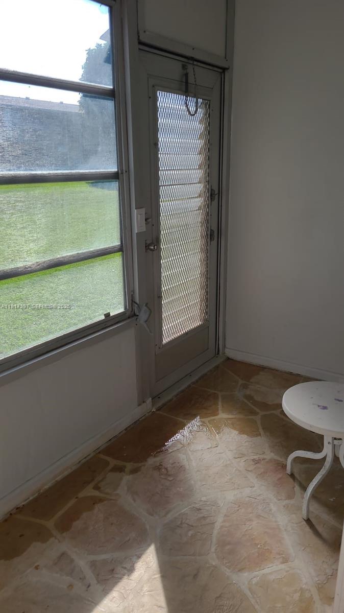 57 Cambridge C, Unit 57 West Palm Beach, FL 33417 - Photo 17 of 36 a view of an empty room and a window