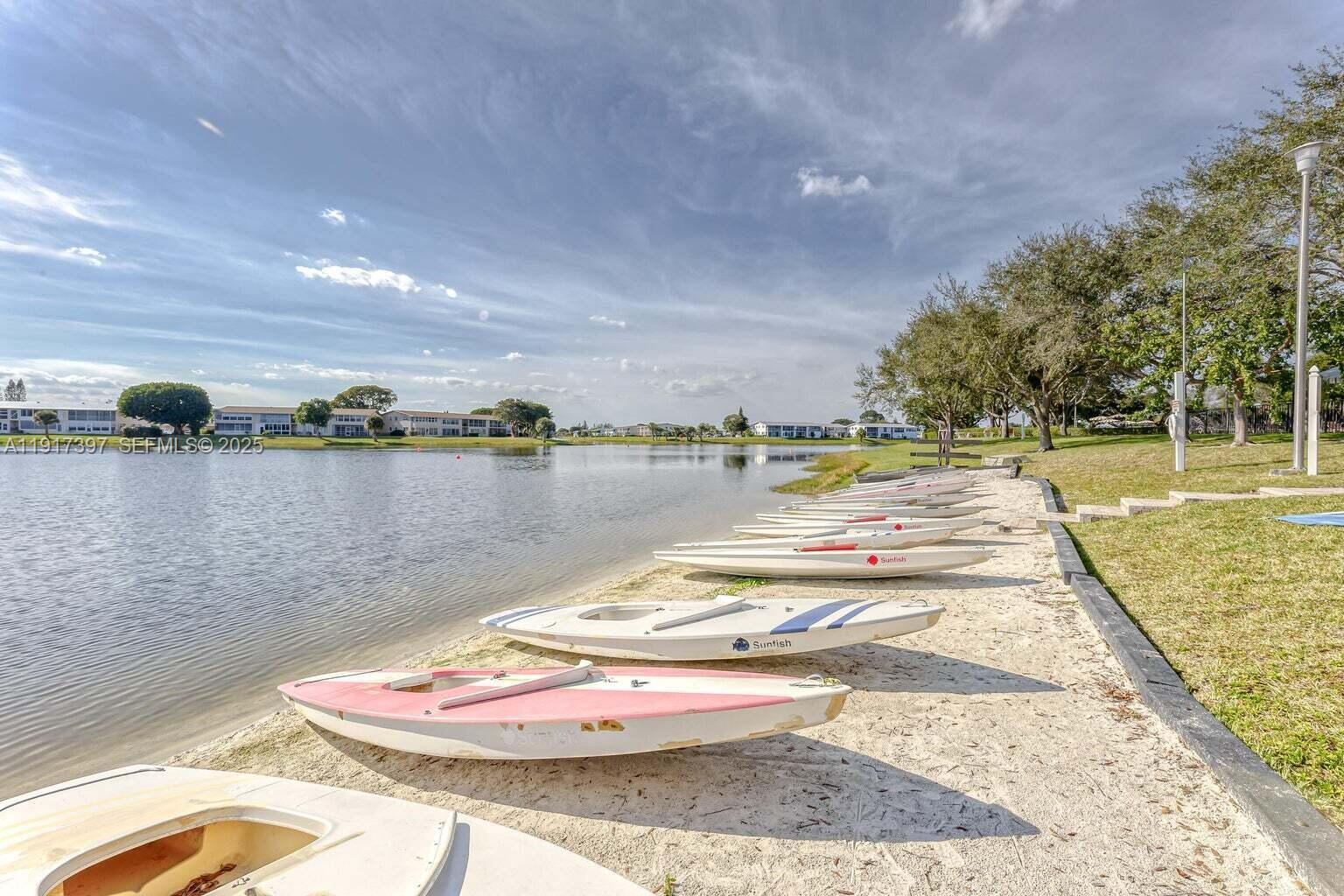 57 Cambridge C, Unit 57 West Palm Beach, FL 33417 - Photo 23 of 36 a view of a lake with a big yard
