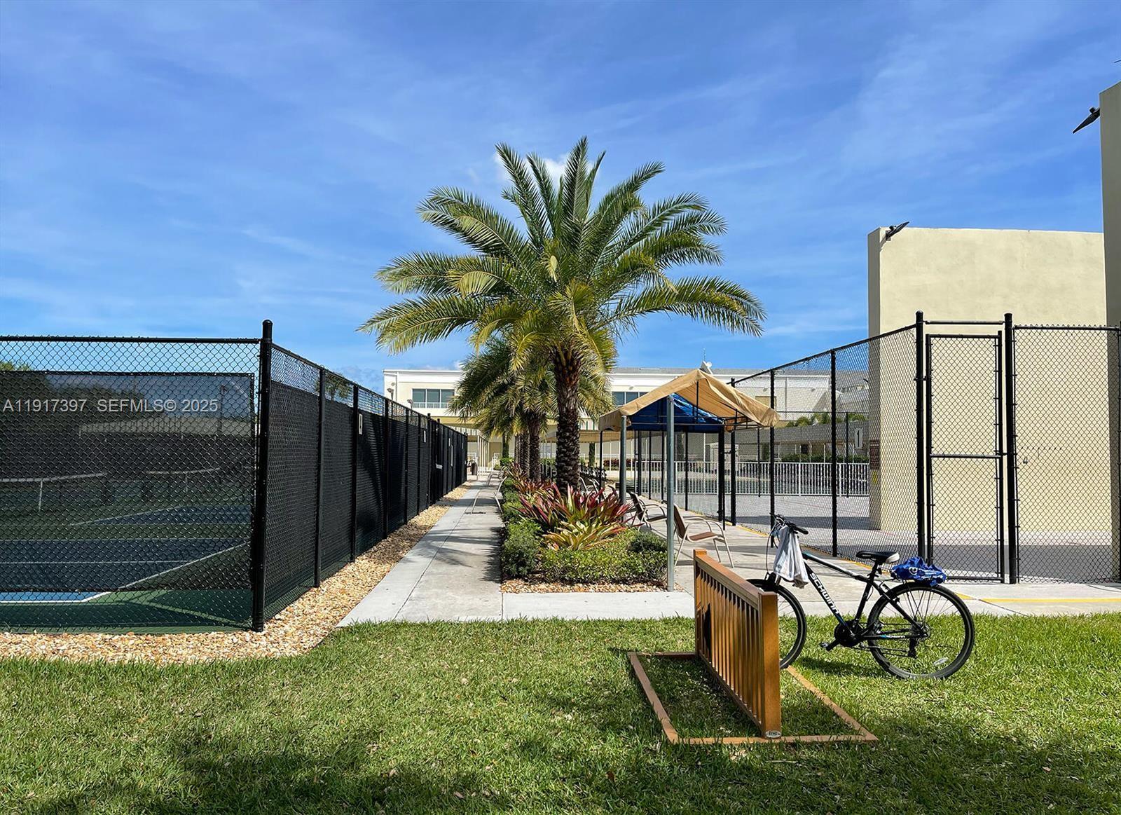 57 Cambridge C, Unit 57 West Palm Beach, FL 33417 - Photo 29 of 36 a view of a chairs and table in backyard