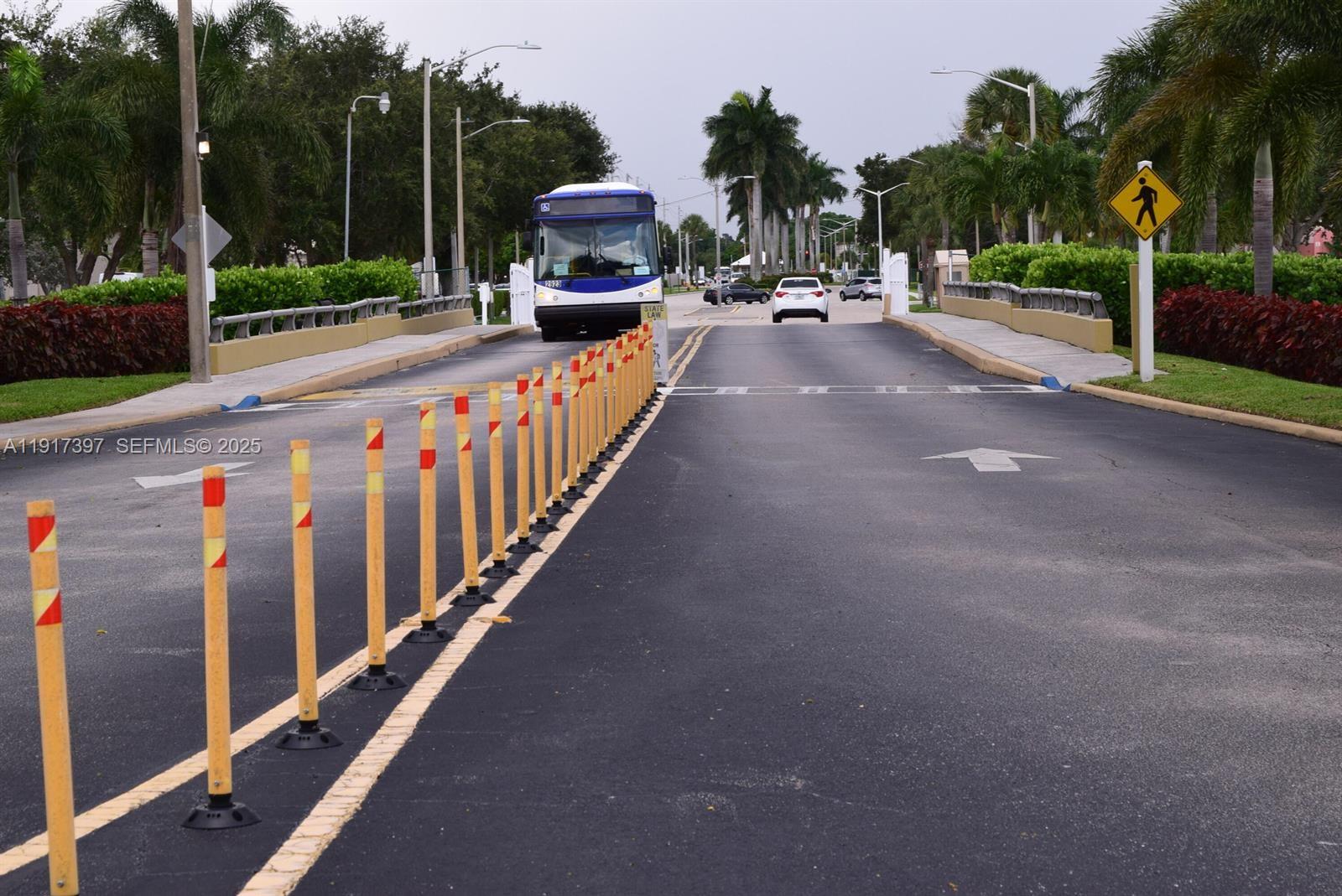57 Cambridge C, Unit 57 West Palm Beach, FL 33417 - Photo 31 of 36 a view of a street with cars on the road