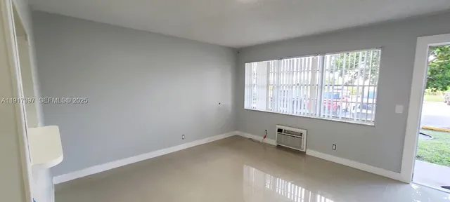 a view of an empty room with a window