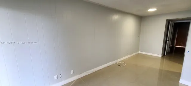 a view of a hallway with paintings on the wall