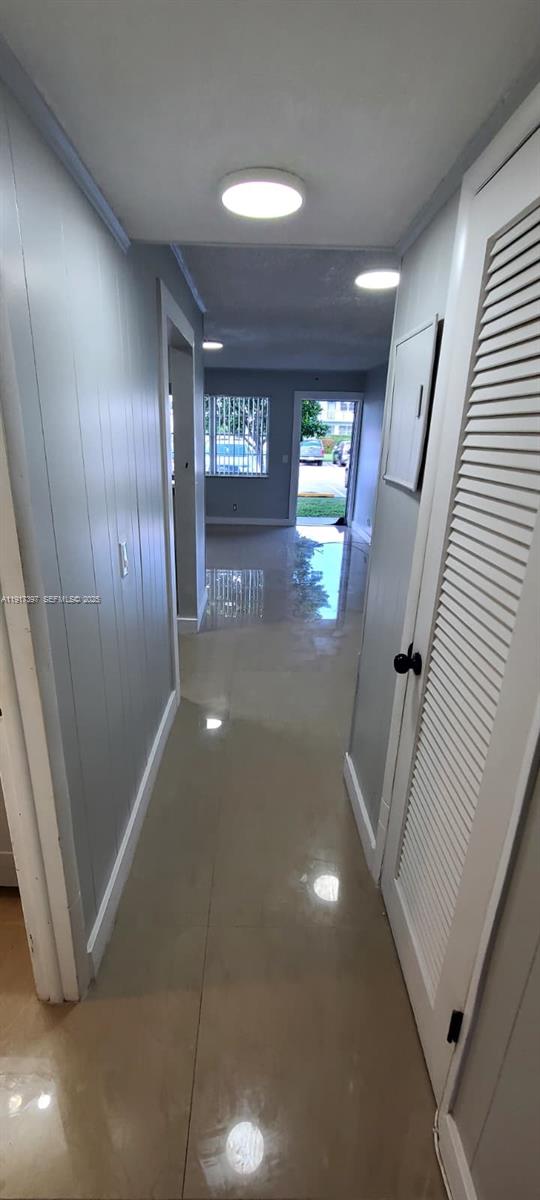 57 Cambridge C, Unit 57 West Palm Beach, FL 33417 - Photo 8 of 36 a view of a hallway with paintings on the wall