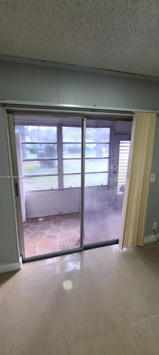 57 Cambridge C, Unit 57 West Palm Beach, FL 33417 - Photo 9 of 36 a view of a livingroom with an empty space and window