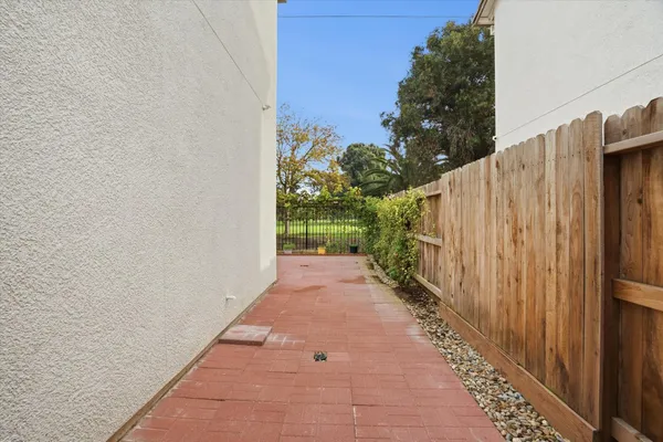 a view of a pathway with a wooden fence