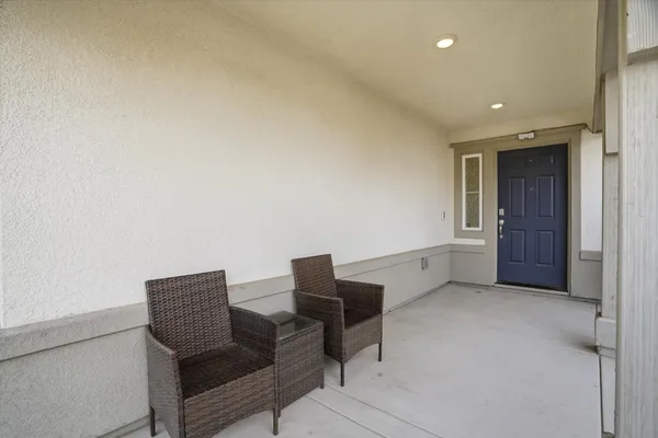 a hallway with chairs and a table in it
