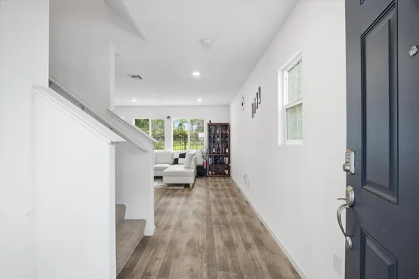 a living room with furniture and a wooden floor