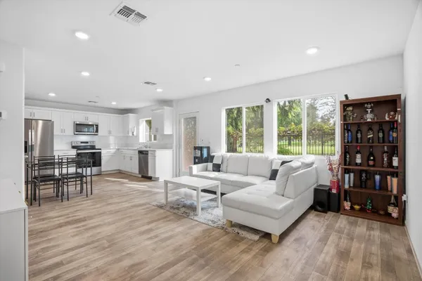 a living room with furniture and a wooden floor