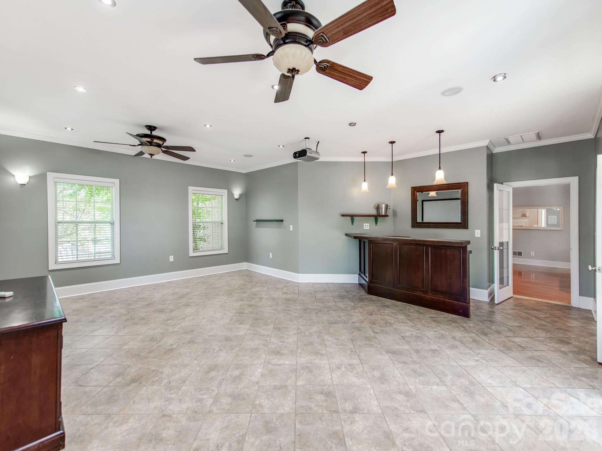 783 Sloan Street Denver, NC 28037 - Photo 13 of 44 a view of a kitchen with a sink and a chandelier fan