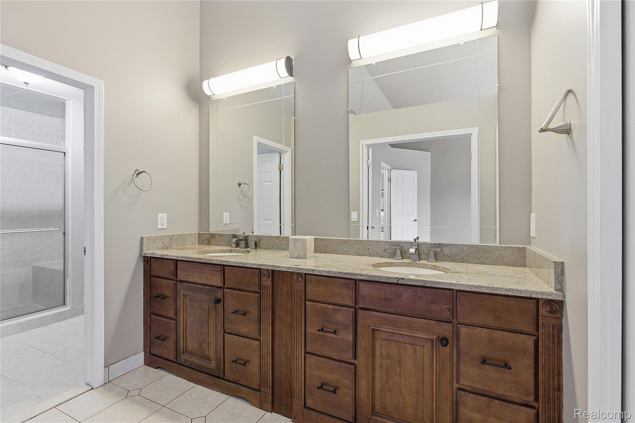 7154 Westchester Road West Bloomfield, MI 48322 - Photo 28 of 38 Full bath featuring double vanity, light tile patterned flooring, and a shower stall