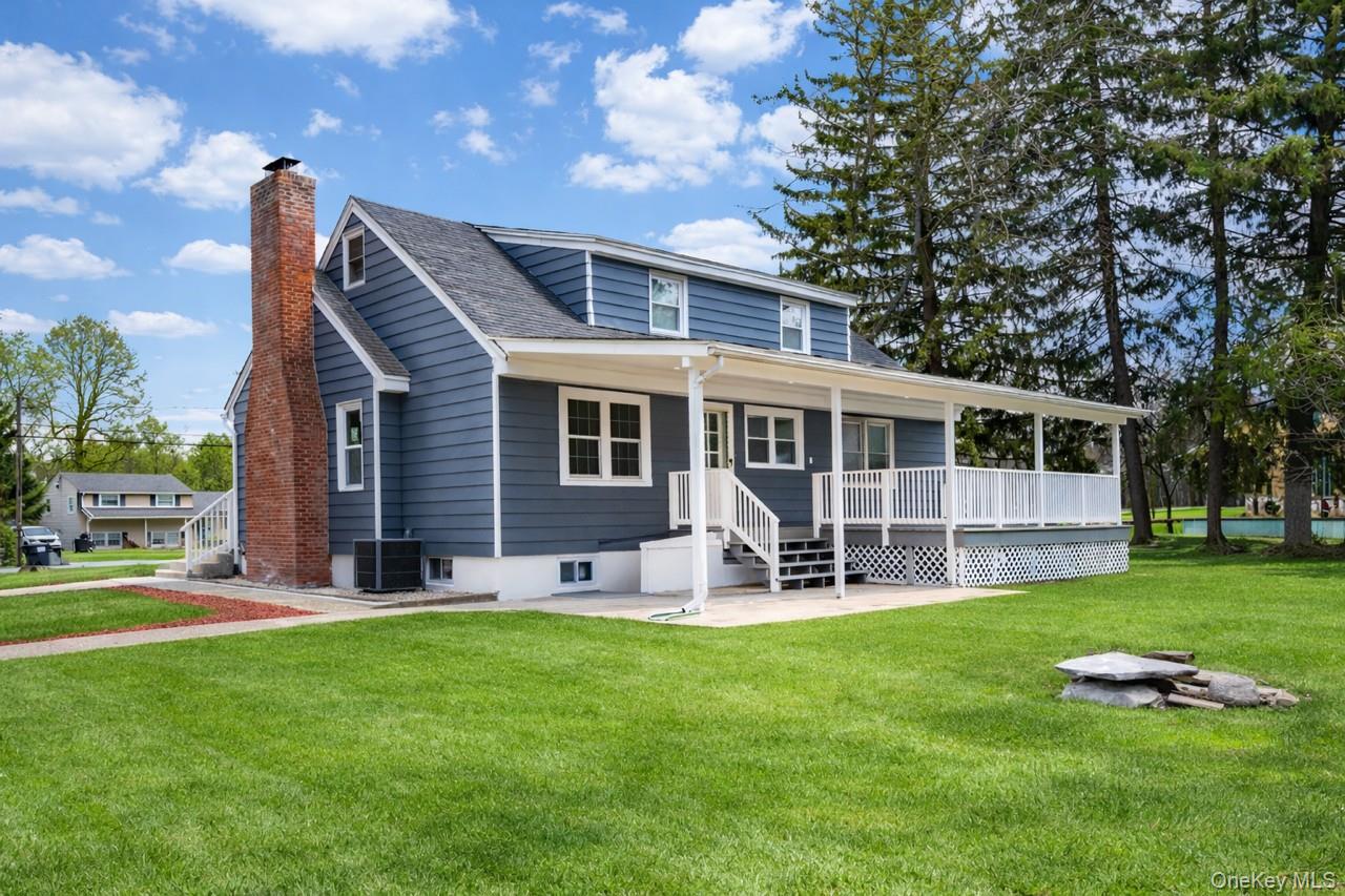a house view with a sitting space and garden