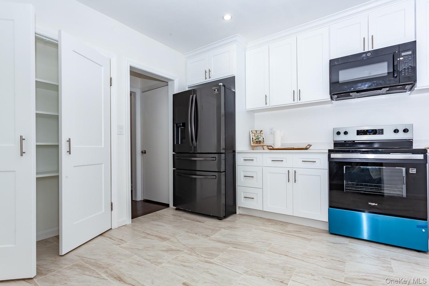 15 Waring Road Newburgh, NY 12550 - Photo 13 of 42 a kitchen with a refrigerator stove and wooden cabinets