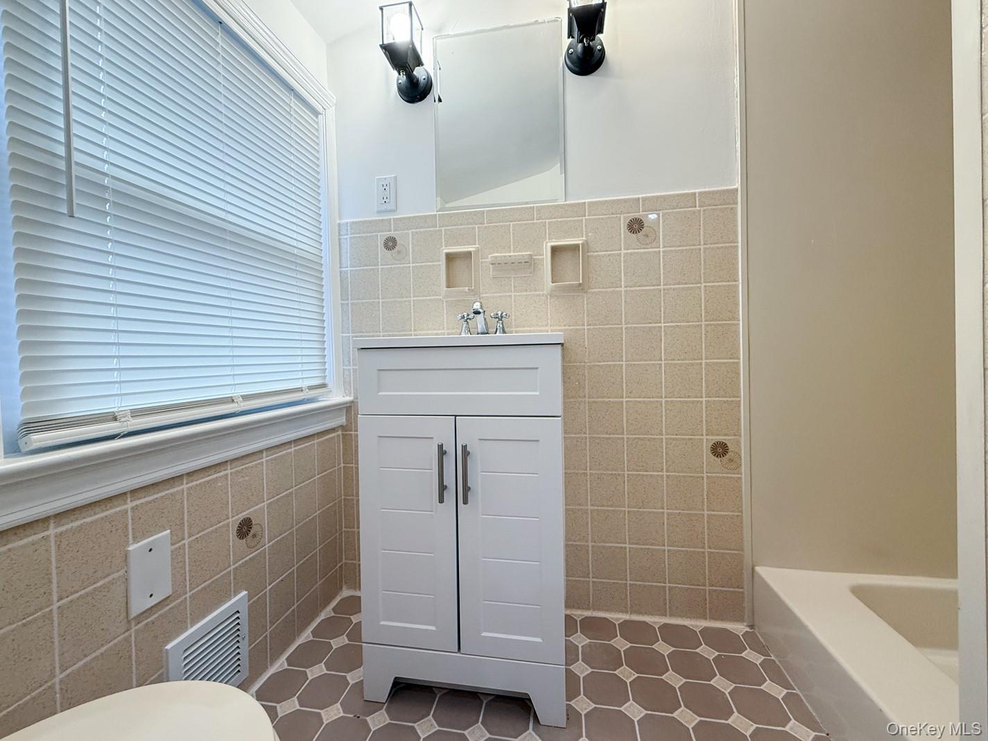 15 Waring Road Newburgh, NY 12550 - Photo 25 of 42 a bathroom with a sink a toilet a mirror and shower