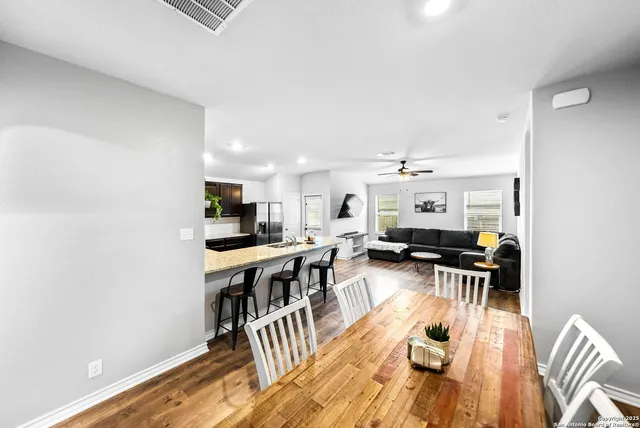 a view of a dining room with furniture wooden floor and chandelier