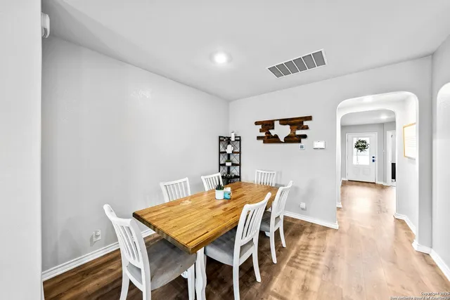 a view of a dining room with furniture and wooden floor